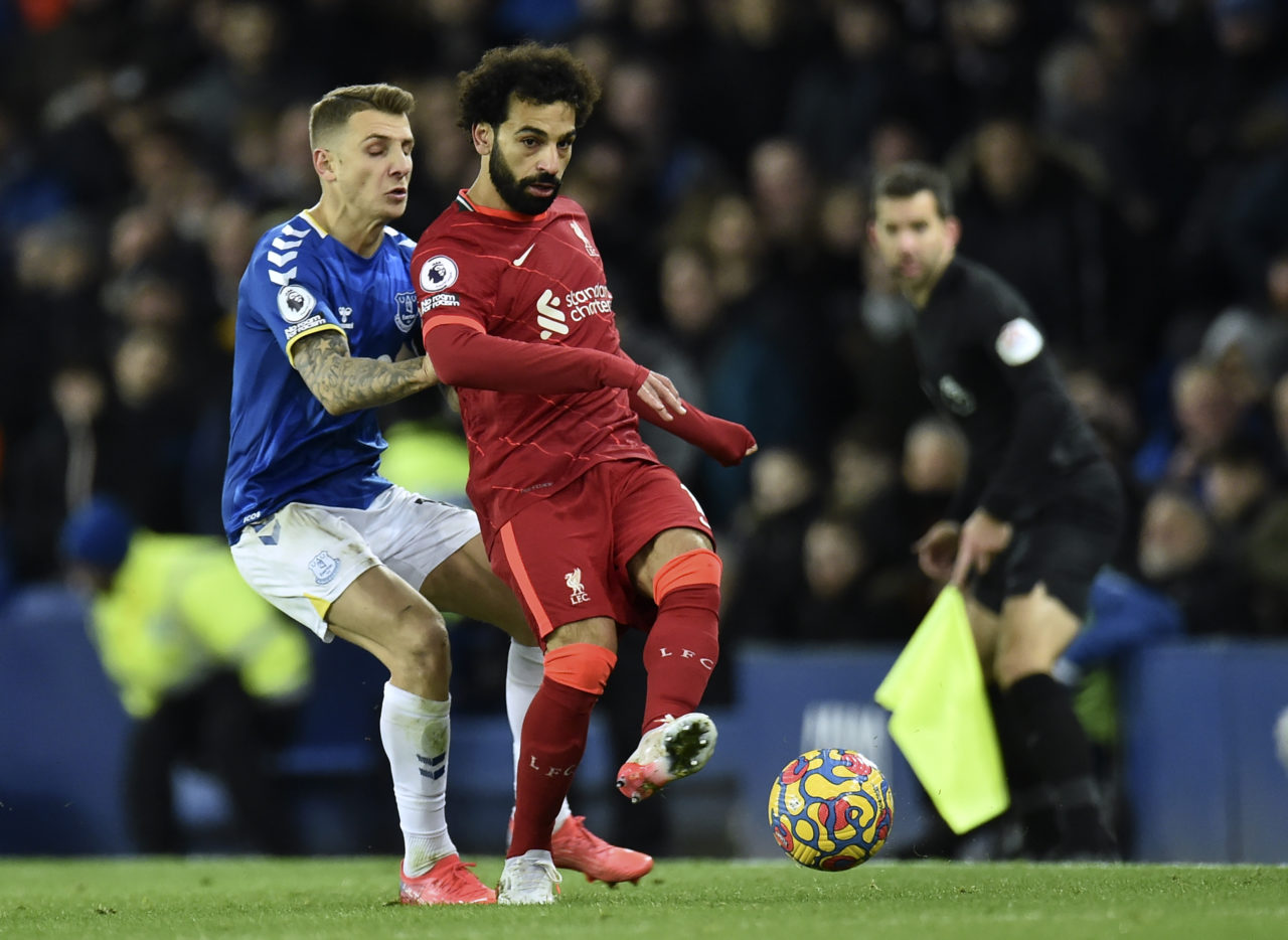 epa09615355 Mohamed Salah (R) of Liverpool in action against Lucas Digne (L) of Everton during the English Premier League soccer match between Everton FC and Liverpool FC in Liverpool, Britain, 01 December 2021. EPA-EFE/PETER POWELL EDITORIAL USE ONLY. No use with unauthorized audio, video, data, fixture lists, club/league logos or 'live' services. Online in-match use limited to 120 images, no video emulation. No use in betting, games or single club/league/player publications